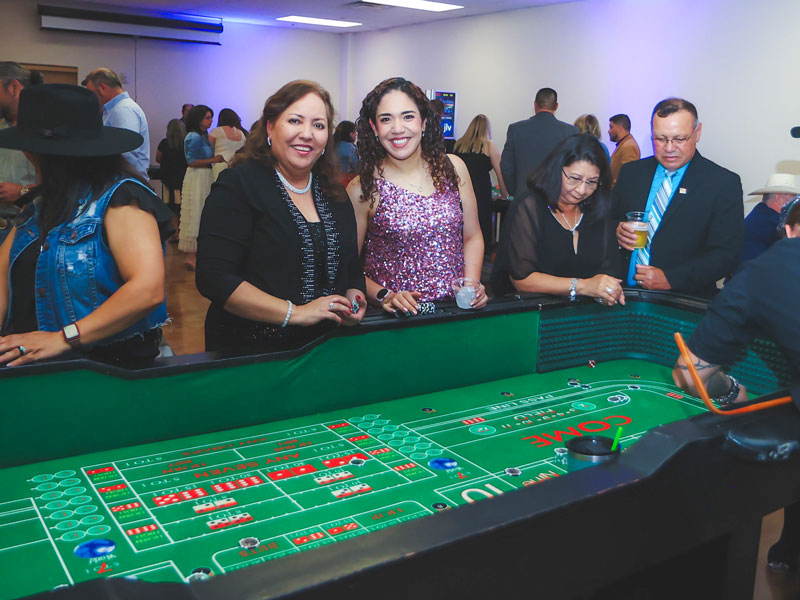 SWTJC Staff Delia Ledesma and Areli Fisher pose for a photo while playing casino games.