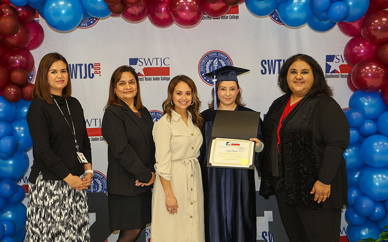 Jessica Beltran (second from the right) receives her GED during the AEL graduation ceremony in Eagle Pass.