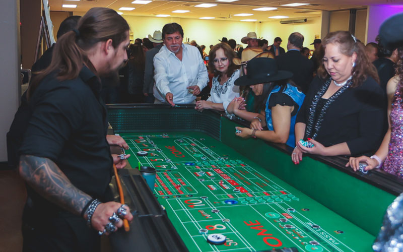 Photo of FAN Gala attendees playing casino games. 