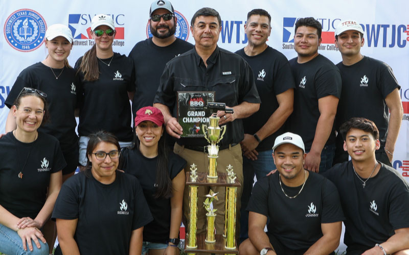 Grand Champion Team "Hot Logs" pose alongside SWTJC President Dr. Hector Gonzales at the 2023 Grillin' with the President Student Cook-Off